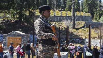 A security person stands guard as tourists line up at Gondola cable car station in Gulmarg. (PTI) A security person stands guard as tourists line up at Gondola cable car station in Gulmarg. (PTI)