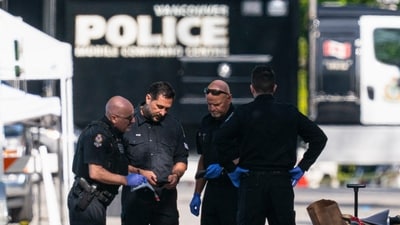 Members of the Vancouver Police forensics team examine a victim's phone while investigating the scene where a vehicle drove into a crowd Saturday killing multiple people at a street festival, in Vancouver, British Columbia, Sunday, April 27, 2025. (The Canadian Press via AP/PTI)(AP04_28_2025_000033B) (AP) Members of the Vancouver Police forensics team examine a victim's phone while investigating the scene where a vehicle drove into a crowd Saturday killing multiple people at a street festival, in Vancouver, British Columbia, Sunday, April 27, 2025. (The Canadian Press via AP/PTI)(AP04_28_2025_000033B) (AP)