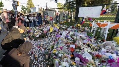 People pay tributes to their loved ones after the Vancouver car ramming attack. (Getty Images via AFP) People pay tributes to their loved ones after the Vancouver car ramming attack. (Getty Images via AFP)