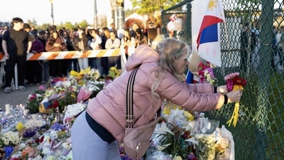 A woman places flowers at a memorial after a vehicle drove into a crowd during a Filipino heritage festival in Vancouver, British Columbia, Sunday, April 27, 2025. (Getty Images via AFP) A woman places flowers at a memorial after a vehicle drove into a crowd during a Filipino heritage festival in Vancouver, British Columbia, Sunday, April 27, 2025. (Getty Images via AFP)