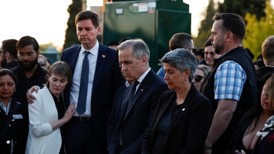 Canada's Prime Minister Mark Carney stands besides British Columbia Premier David Eby at a memorial near the scene of an incident where a vehicle was driven into a crowd at a Filipino community Lapu Lapu Day block party, in Vancouver, British Columbia, Canada April 27, 2025. REUTERS/Carlos Osorio (REUTERS)