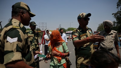 A military personnel with Border Security Force checks passports of Pakistani citizens as they prepare to leave India. (Reuters file photo)