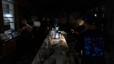 A client lights up the menu of a restaurant with a cell phone light after Puerto Rico was hit with a massive power outage where energy plants across the island unexpectedly shut down, in San Juan, Puerto Rico April 16, 2025.  REUTERS/Ricardo Arduengo (REUTERS)