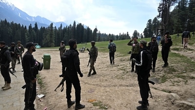 Security personnel inspect the site in the aftermath of an attack as food stall chairs lie empty in Pahalgam. (AFP) Security personnel inspect the site in the aftermath of an attack as food stall chairs lie empty in Pahalgam. (AFP)