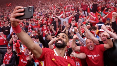 Mohamed Salah takes a selfie with fans. (REUTERS)