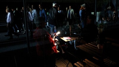 A woman at Tennis - Madrid Open - Park Manzanares uses her cell phone's flashlight in the dark after the matches get suspended due to a power outage REUTERS/Violeta Santos Moura (REUTERS)