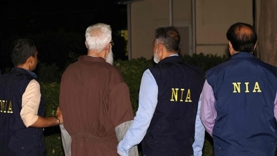 National Investigation Agency (NIA) officials along with Tahawwur Hussain Rana. (AFP file photo) National Investigation Agency (NIA) officials along with Tahawwur Hussain Rana. (AFP file photo)