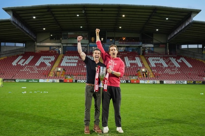Wrexham co-owners Rob McElhenney, left, and Ryan Reynolds pose with trophy at the end of the English League One soccer match between Wrexham and Charlton Athletic at the Racecourse ground in Wrexham, Wales, Saturday, April 26, 2025. (AP Photo/Jon Super) (AP) Wrexham co-owners Rob McElhenney, left, and Ryan Reynolds pose with trophy at the end of the English League One soccer match between Wrexham and Charlton Athletic at the Racecourse ground in Wrexham, Wales, Saturday, April 26, 2025. (AP Photo/Jon Super) (AP)