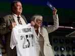 Melanie Salata Fitch, right, announces Memphis' Kobee Minor as the final pick by New England Patriots the during the third day of the NFL football draft, Saturday, April 26, 2025, in Green Bay, Wis. (AP Photo/Matt Ludtke) Melanie Salata Fitch, right, announces Memphis' Kobee Minor as the final pick by New England Patriots the during the third day of the NFL football draft, Saturday, April 26, 2025, in Green Bay, Wis. (AP Photo/Matt Ludtke)