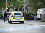 A Police officer works near the scene where several people were injured after a series of loud bangs that indicated gunfire at Vaksala Square in Uppsala, Sweden.