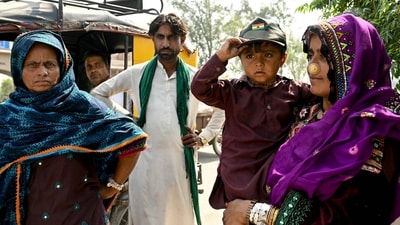 Indian citizens return from Pakistan through the India-Pakistan Wagah border post after Islamabad revoked visas of Indian nationals. (AFP) Indian citizens return from Pakistan through the India-Pakistan Wagah border post after Islamabad revoked visas of Indian nationals. (AFP)