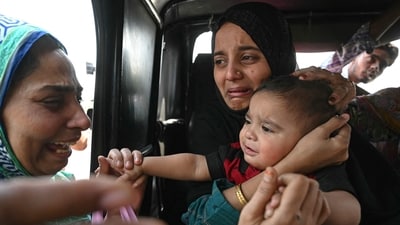 A Pakistani citizen (C) bids goodbye to her son, an Indian citizen, as she prepares to return to her country through the India-Pakistan Wagah border post, about 35 km from Amritsar on April 29, 2025. (AFP) A Pakistani citizen (C) bids goodbye to her son, an Indian citizen, as she prepares to return to her country through the India-Pakistan Wagah border post, about 35 km from Amritsar on April 29, 2025. (AFP)