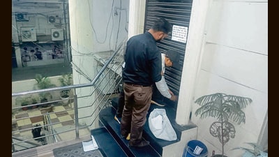 MC officials sealing the illegal office block of Maria Group in Dhaulagiri Apartments on Mall road, Ludhiana, on Tuesday. (HT Photo)