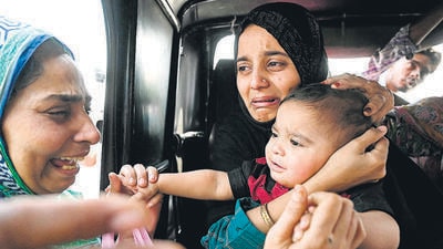 Pakistani citizen bids goodbye to her son as she prepares to return to her country through the India-Pakistan Wagah border post on Tuesday. (AFP) Pakistani citizen bids goodbye to her son as she prepares to return to her country through the India-Pakistan Wagah border post on Tuesday. (AFP)