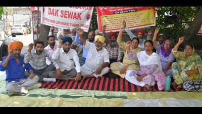 Postal staff staging protest at the Head Post Office in Ludhiana on Tuesday. (Manish/HT) Postal staff staging protest at the Head Post Office in Ludhiana on Tuesday. (Manish/HT)