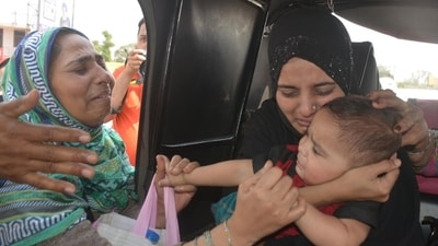 Before crossing over the border at Attari-Wagah border check post, a Pakistan woman (R) bids a teary goodbye to her baby, an Indian citizen, after she was not allowed to accompany her following curbs imposed at the border in wake of Pahalgam terror attack. (Sameer Sehgal/HT) Before crossing over the border at Attari-Wagah border check post, a Pakistan woman (R) bids a teary goodbye to her baby, an Indian citizen, after she was not allowed to accompany her following curbs imposed at the border in wake of Pahalgam terror attack. (Sameer Sehgal/HT)