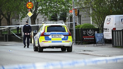 A Police officer works near the scene where several people were injured after a series of loud bangs that indicated gunfire at Vaksala Square in Uppsala, Sweden. (REUTERS)
