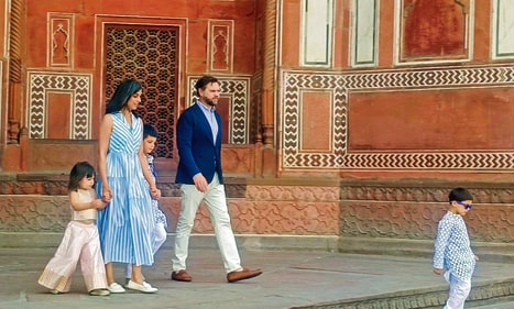 Usha channels holiday elegance in a striped dress and white loafers."