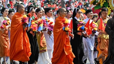 Buddhist monks and Catholic nuns take part a parade marking the 50th anniversary of the fall of Saigon and the end of the Vietnam War in Ho Chi Minh City on April 30, 2025. Vietnam held its biggest celebration of the fall of Saigon on its 50th anniversary on April 30, including Chinese troops for the first time after Xi Jinping visited to portray Beijing as a more reliable partner than Washington. (Photo by NHAC NGUYEN / AFP) (AFP) Buddhist monks and Catholic nuns take part a parade marking the 50th anniversary of the fall of Saigon and the end of the Vietnam War in Ho Chi Minh City on April 30, 2025. Vietnam held its biggest celebration of the fall of Saigon on its 50th anniversary on April 30, including Chinese troops for the first time after Xi Jinping visited to portray Beijing as a more reliable partner than Washington. (Photo by NHAC NGUYEN / AFP) (AFP)