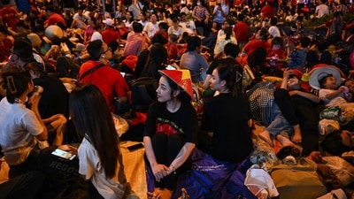 Spectators waiting overnight sit along a road to reserve their spot in Ho Chi Minh City in the early hours of on April 30, 2025, ahead of a parade marking the 50th anniversary of the fall of Saigon and the end of the Vietnam War. Vietnam held its biggest celebration of the fall of Saigon on its 50th anniversary on April 30, including Chinese troops for the first time after Xi Jinping visited to portray Beijing as a more reliable partner than Washington. (Photo by MANAN VATSYAYANA / AFP) (AFP) Spectators waiting overnight sit along a road to reserve their spot in Ho Chi Minh City in the early hours of on April 30, 2025, ahead of a parade marking the 50th anniversary of the fall of Saigon and the end of the Vietnam War. Vietnam held its biggest celebration of the fall of Saigon on its 50th anniversary on April 30, including Chinese troops for the first time after Xi Jinping visited to portray Beijing as a more reliable partner than Washington. (Photo by MANAN VATSYAYANA / AFP) (AFP)