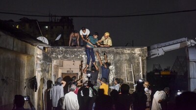 Firefighters evacuate people after a fire broke out at a hotel at Mechua in Kolkata on Tuesday. (PTI) Firefighters evacuate people after a fire broke out at a hotel at Mechua in Kolkata on Tuesday. (PTI)