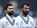 India's Virat Kohli (L) and India's Cheteshwar Pujara