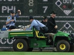 Stadium security and Pittsburgh Pirates medical personnel cart a fan who fell from the stands to the field to an ambulance 