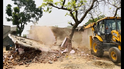 A house belonging to a “drug smuggler” being demolished in Dhamot Kalan village. (HT Photo) A house belonging to a “drug smuggler” being demolished in Dhamot Kalan village. (HT Photo)