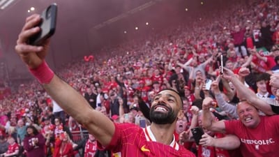 Liverpool's Mohamed Salah celebrates by taking a selfie after winning the English Premier League soccer match between Liverpool and Tottenham Hotspur and clinching the Premier League title at Anfield in Liverpool, England, Sunday, April 27, 2025. (Jon Super/AP)