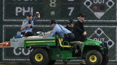 Stadium security and Pittsburgh Pirates medical personnel cart a fan who fell from the stands to the field to an ambulance (IMAGN IMAGES via Reuters Connect)