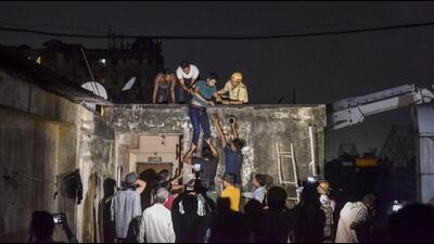 Firefighters rescues people after a fire broke out at a hotel in Kolkata’s Mechua Bazar. (PTI)
