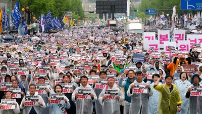 Members of the Korean Confederation of Trade Unions gather to attend a rally on May Day in Seoul, South Korea, Thursday, May 1, 2025. The letters read "Let's win basic labor rights." (AP) Members of the Korean Confederation of Trade Unions gather to attend a rally on May Day in Seoul, South Korea, Thursday, May 1, 2025. The letters read "Let's win basic labor rights." (AP)