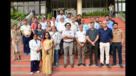 Around 30 faculty members, wearing black badges, gathered outside the administrative block to mark the first day of their protest. (Ravi Kumar/HT)