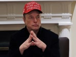 FILE PHOTO: Tesla CEO Elon Musk wears a 'Trump Was Right About Everything!' hat while attending a cabinet meeting at the White House, in Washington, D.C., U.S., March 24, 2025. REUTERS/Carlos Barria/File Photo