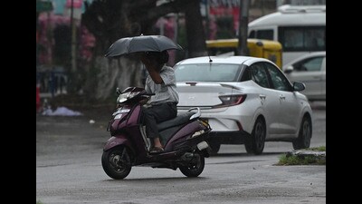 A scooterist braving the rain in Sector 22, Chandigarh, on Friday. The rain caused the mercury to drop to 31.1°C. (Keshav Singh/HT) A scooterist braving the rain in Sector 22, Chandigarh, on Friday. The rain caused the mercury to drop to 31.1°C. (Keshav Singh/HT)