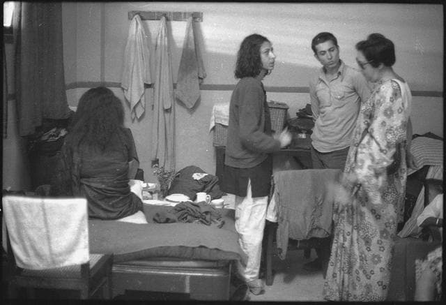 (Original caption) 20 March 1975 - Occupying a corner of a second class waiting room at the New Delhi Railway Station for the past three months are a mother (45), daughter (19), and son (17). She is Wilayat Mahal who claims to be a great-granddaughter of Hazarat Mahal, wife of Wajid All Shah the last Nawab of Oudh. Wilayat Mahal is the widow of Inayat Husain who was acting Vice Chancellor of Lucknow University at the time of the Partition. Inayat Husain and Wilayat Mahal crossed over to Pakistan where he rose to the position of Defence Secretary. After the assassination of Liaquat Ali Khan, Inayat Husain was in difficulties and later died. His widow and three children returned to India in the early sixties. According to Wilayat Mahal, there were allegations that Inayat Husain had a hand in the murder of Liaquat Ali Khan which, according to her, were baseless. On arrival in New Delhi a little while before Jawaharlal Nehru's death, the young widow and her children met the Prime Minister. He consoled them. Ordered a maintenance allowance of ₹300 per month for the family and had a bungalow in Nishat Bagh, Srinagar Kashmir, allotted to them. He promised that the three children would be given facilities for education. The family settled down in Srinagar. The small allowance of ₹300 was not sufficient for their upkeep. But Wilayat Mahal had brought ornaments, carpets and heirlooms worth about ₹7 lakhs with her. Some of these she sold from time to time for the family's upkeep and education. Her elder son, now 20 and a fine cricketer, studied up to the Intermediate, her daughter, Sakeena, up to pre-medical and her younger son, All Raza, up to Higher Secondary. The stigma of the allegations against Inayat Husain, according to his widow, was never allowed to be forgotten by some elements in Kashmir. On April 29, 1971 their house in Nishat Bagh was burnt. Last year, Wilayat Mahal's maintenance allowance was increased from ₹300 to ₹500. But the family is extremely keen on moving from Srinagar to Lucknow, their original home. Sakeena and Ali Raza want to become doctors. While the mother and her two younger children are in the capital, lying in the New Delhi Railway Station waiting room, the elder son is holding the fort in Srinagar, keeping watch over the family's remaining possessions. They met the Prime Minister on New Year's Day, this year and later the Ministers for Home Affairs and Railways and the Deputy Chairman of the Planning Commission. Everyone has promised help, but government machinery takes its own time to move. "We are at breaking point, having to live in a corner of the waiting room," they say. But they determinedly add. "We shall not go back to Kashmir" (HT Photo by N Thyagarajan.) (Original caption) 20 March 1975 - Occupying a corner of a second class waiting room at the New Delhi Railway Station for the past three months are a mother (45), daughter (19), and son (17). She is Wilayat Mahal who claims to be a great-granddaughter of Hazarat Mahal, wife of Wajid All Shah the last Nawab of Oudh. Wilayat Mahal is the widow of Inayat Husain who was acting Vice Chancellor of Lucknow University at the time of the Partition. Inayat Husain and Wilayat Mahal crossed over to Pakistan where he rose to the position of Defence Secretary. After the assassination of Liaquat Ali Khan, Inayat Husain was in difficulties and later died. His widow and three children returned to India in the early sixties. According to Wilayat Mahal, there were allegations that Inayat Husain had a hand in the murder of Liaquat Ali Khan which, according to her, were baseless. On arrival in New Delhi a little while before Jawaharlal Nehru's death, the young widow and her children met the Prime Minister. He consoled them. Ordered a maintenance allowance of ₹300 per month for the family and had a bungalow in Nishat Bagh, Srinagar Kashmir, allotted to them. He promised that the three children would be given facilities for education. The family settled down in Srinagar. The small allowance of ₹300 was not sufficient for their upkeep. But Wilayat Mahal had brought ornaments, carpets and heirlooms worth about ₹7 lakhs with her. Some of these she sold from time to time for the family's upkeep and education. Her elder son, now 20 and a fine cricketer, studied up to the Intermediate, her daughter, Sakeena, up to pre-medical and her younger son, All Raza, up to Higher Secondary. The stigma of the allegations against Inayat Husain, according to his widow, was never allowed to be forgotten by some elements in Kashmir. On April 29, 1971 their house in Nishat Bagh was burnt. Last year, Wilayat Mahal's maintenance allowance was increased from ₹300 to ₹500. But the family is extremely keen on moving from Srinagar to Lucknow, their original home. Sakeena and Ali Raza want to become doctors. While the mother and her two younger children are in the capital, lying in the New Delhi Railway Station waiting room, the elder son is holding the fort in Srinagar, keeping watch over the family's remaining possessions. They met the Prime Minister on New Year's Day, this year and later the Ministers for Home Affairs and Railways and the Deputy Chairman of the Planning Commission. Everyone has promised help, but government machinery takes its own time to move. "We are at breaking point, having to live in a corner of the waiting room," they say. But they determinedly add. "We shall not go back to Kashmir" (HT Photo by N Thyagarajan.)