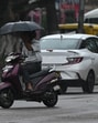 A scooterist braving the rain in Sector 22, Chandigarh, on Friday. The rain caused the mercury to drop to 31.1°C. (Keshav Singh/HT)