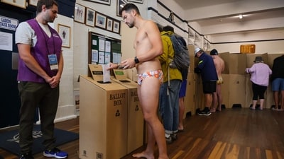 An official keeps watch as a man votes in Australia's general election at a polling station at the Bondi Surf Bathers Life Saving Club in Sydney on May 3, 2025. (AFP) An official keeps watch as a man votes in Australia's general election at a polling station at the Bondi Surf Bathers Life Saving Club in Sydney on May 3, 2025. (AFP)