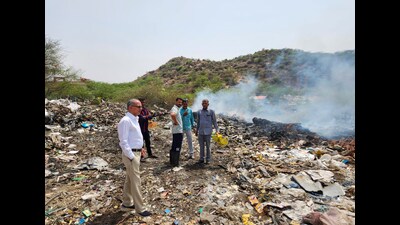 Administrative officials visit the spot where rampant burning of chemical waste occurs in Khori village near the Rajasthan border on Saturday. (Parveen Kumar/HT PHOTO)