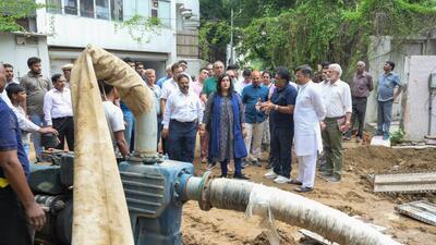 Delhi PWD minister Parvesh Verma and BJP MP Bansuri Swaraj inspect a road after heavy rainfall at Golf Links in New Delhi on Saturday. (RAJ K RAJ /HT PHOTO)