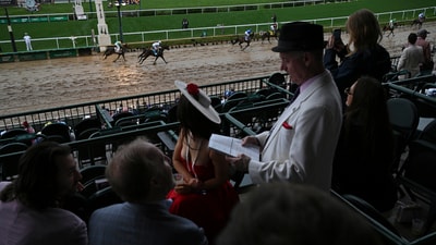 Kentucky Derby 2025: Race fans are seen in the stands as horses pass at Churchill Downs before the 151st running of the Kentucky Derby horse race Saturday, May 3, 2025, in Louisville, Ky. (AP Photo/Jon Cherry) (AP)