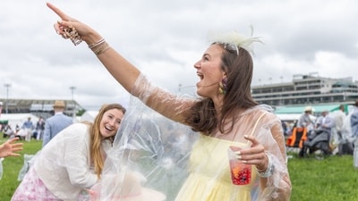 Fans pose for pictures ahead of the 151st running of the Kentucky Derby at Churchill Downs on May 3, 2025, in Louisville, Kentucky. (Photo by LEANDRO LOZADA / AFP) (AFP) Fans pose for pictures ahead of the 151st running of the Kentucky Derby at Churchill Downs on May 3, 2025, in Louisville, Kentucky. (Photo by LEANDRO LOZADA / AFP) (AFP)