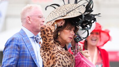 A woman adjusts her hat at the 2025 Kentucky Derby at Churchill Downs in Louisville, Kentucky. May 3, 2025 Mandatory Credit: Matt Stone/USA TODAY NETWORK via Imagn Images (IMAGN IMAGES via Reuters Connect)