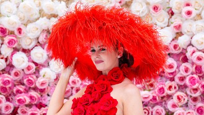 Emily Lowery of Pittsburgh wears a large red hat with a red rose dress for the 2025 Kentucky Derby at Churchill Downs in Louisville, Kentucky. May 3, 2025 Mandatory Credit: Matt Stone/USA TODAY NETWORK via Imagn Images (IMAGN IMAGES via Reuters Connect)