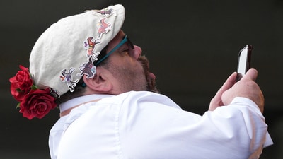Eric Ortega snaps a photo of his wife Shanda and daughter Isa for the 2025 Kentucky Derby at Churchill Downs in Louisville, Kentucky. May 3, 2025 Mandatory Credit: Matt Stone/USA TODAY NETWORK via Imagn Images (IMAGN IMAGES via Reuters Connect)