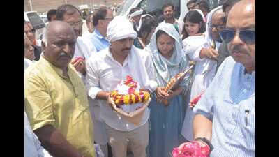 Wife of Shubham Dwivedi, Ashanya, carrying a photograph while his brother, Saurabh carries the urn with ashes during immersion of ashes of her husband along with family members at Sangam on Saturday. (Anil Kumar Maurya/ht)