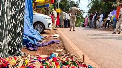 Belongings and other material lie on a roadside as police personnel investigate the site after a stampede broke out at a village during a temple festival, in North Goa district, Saturday, May 3. (PTI) Belongings and other material lie on a roadside as police personnel investigate the site after a stampede broke out at a village during a temple festival, in North Goa district, Saturday, May 3. (PTI)