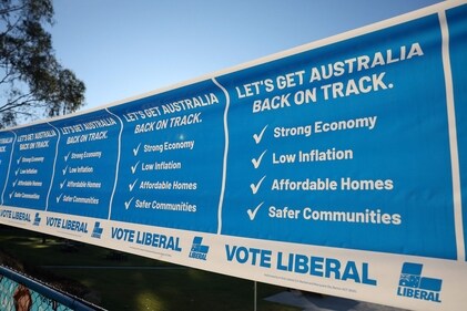 A poster encourages voters to 'vote Liberal' as voters wait to cast their ballots in Australia's general election at a polling station in Melbourne on May 3, 2025. (AFP) A poster encourages voters to 'vote Liberal' as voters wait to cast their ballots in Australia's general election at a polling station in Melbourne on May 3, 2025. (AFP)