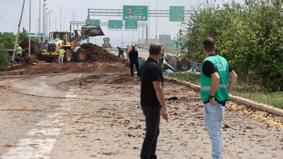 Israeli emergency services clear a road outside Israel's Ben Gurion airport after a missile reportedly launched from Yemen struck near the facility on May 4, 2025. (AFP) Israeli emergency services clear a road outside Israel's Ben Gurion airport after a missile reportedly launched from Yemen struck near the facility on May 4, 2025. (AFP)