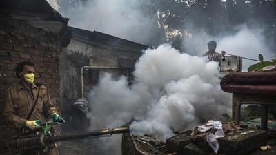 Mumbai, India - September 24, 2016: A BMC staffer conducts a fumigation near a well in a Mumbai locality. The BMC staff identify, treat and eliminate breeding of dengue transmitting Aedes mosquitoes which spreads in Mumbai, India, on Friday, September 24, 2016. (Photo by Satish Bate/ Hindustan Times) (Satish Bate/HT PHOTO) Mumbai, India - September 24, 2016: A BMC staffer conducts a fumigation near a well in a Mumbai locality. The BMC staff identify, treat and eliminate breeding of dengue transmitting Aedes mosquitoes which spreads in Mumbai, India, on Friday, September 24, 2016. (Photo by Satish Bate/ Hindustan Times) (Satish Bate/HT PHOTO)